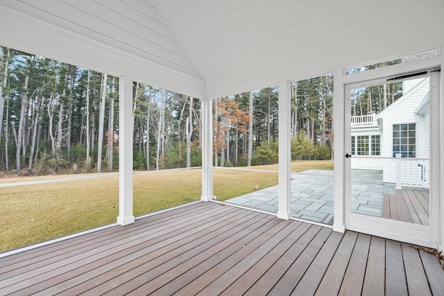 unfurnished sunroom featuring vaulted ceiling