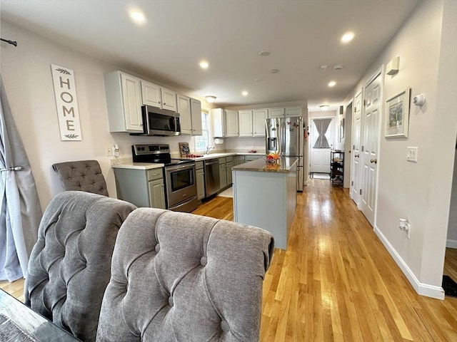 121 Camp St Unit 108, Yarmouth, MA 02673 - kitchen with stainless steel appliances, light wood-style floors, a center island, a sink, and recessed lighting