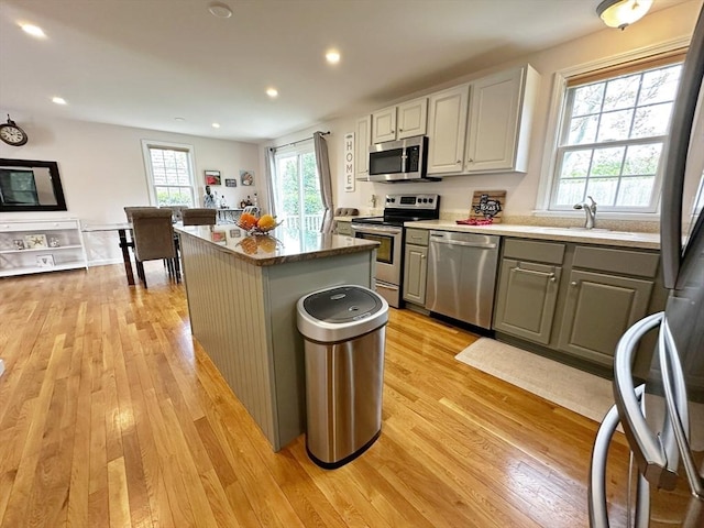 121 Camp St Unit 108, Yarmouth, MA 02673 - kitchen with stainless steel appliances, a sink, light wood-style flooring, a kitchen island, and recessed lighting