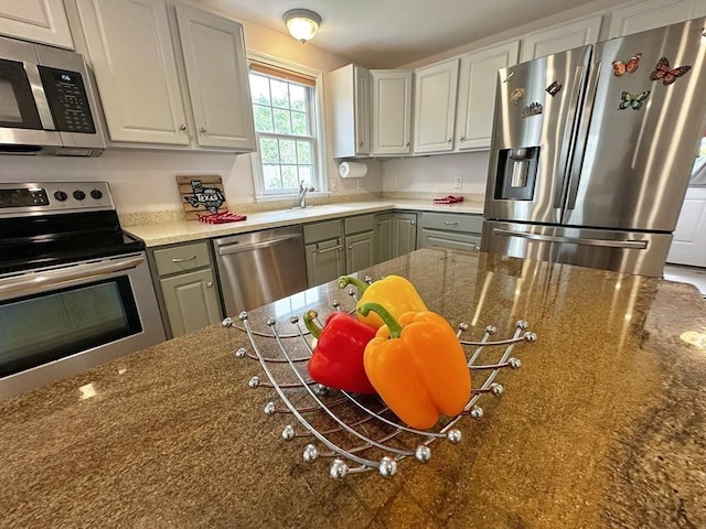 121 Camp St Unit 108, Yarmouth, MA 02673 - kitchen with stainless steel appliances, gray cabinets, a sink, and dark stone countertops