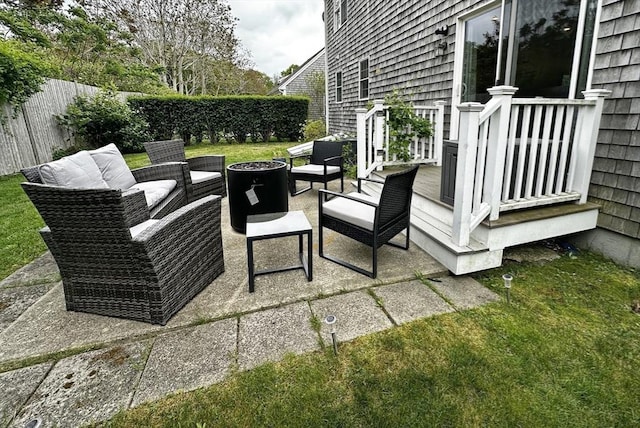 121 Camp St Unit 108, Yarmouth, MA 02673 - fenced backyard with a fire pit and a patio area