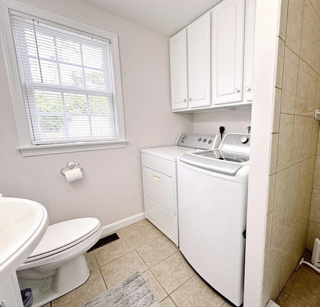 121 Camp St Unit 108, Yarmouth, MA 02673 - laundry room with separate washer and dryer, light tile patterned floors, and baseboards