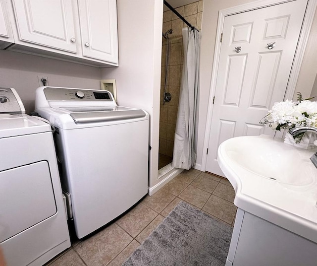 121 Camp St Unit 108, Yarmouth, MA 02673 - washroom with washing machine and dryer, light tile patterned floors, and a sink