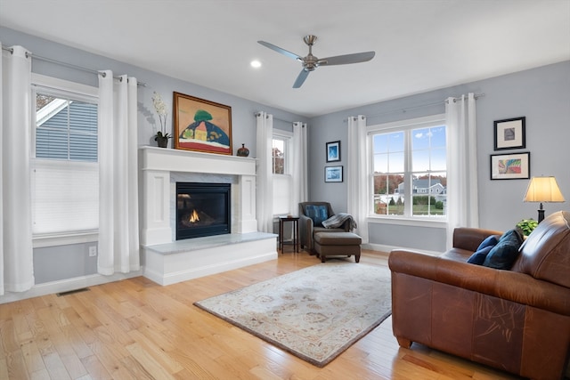 living room with ceiling fan and light hardwood / wood-style floors