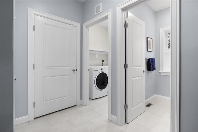 laundry room with light tile patterned floors and washer / clothes dryer