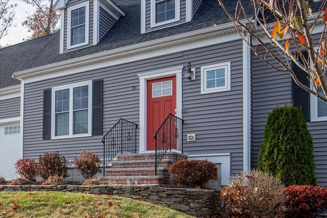 view of exterior entry with a garage