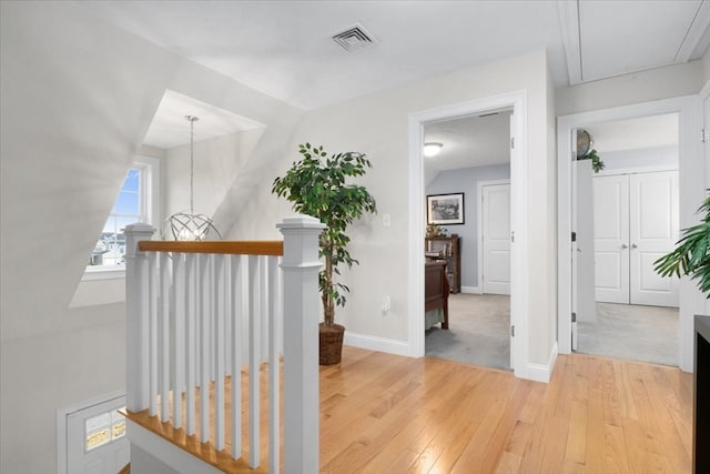 hallway featuring light colored carpet