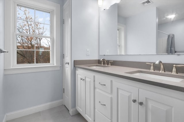 bathroom with tile patterned floors and vanity