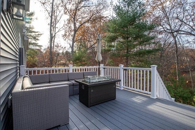 wooden deck with an outdoor living space with a fire pit