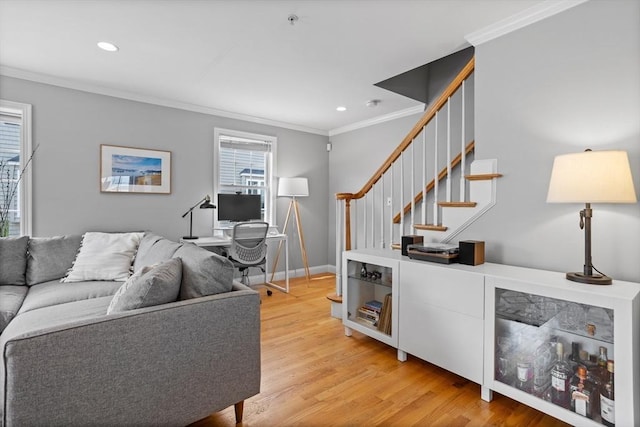 living room featuring ornamental molding and light hardwood / wood-style flooring