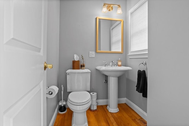 bathroom with sink, toilet, and wood-type flooring