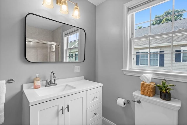 bathroom with toilet, a shower with door, and vanity