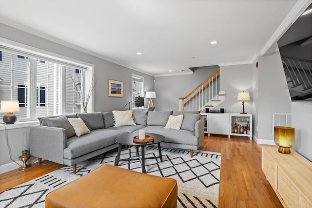 living room with hardwood / wood-style flooring and ornamental molding