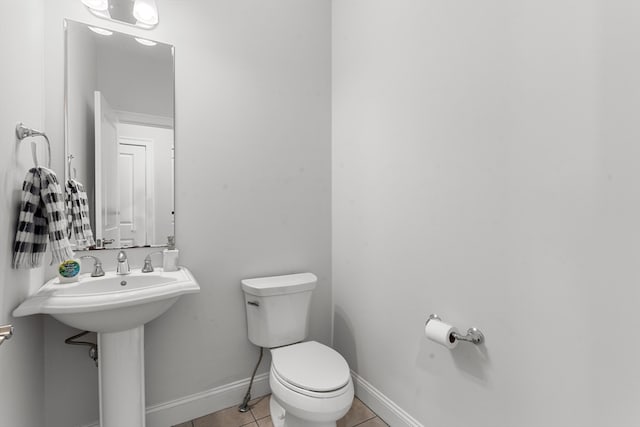 bathroom featuring tile patterned flooring and toilet