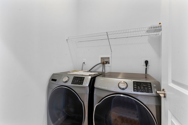 laundry area with washing machine and clothes dryer