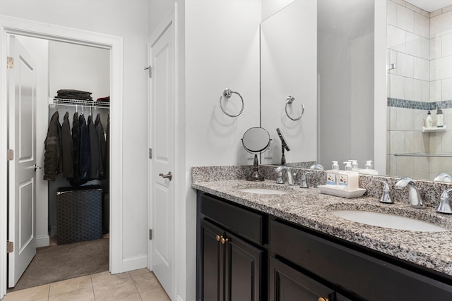 bathroom featuring tile patterned flooring, vanity, and an enclosed shower