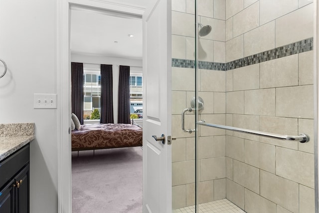 bathroom featuring vanity and a shower with shower door