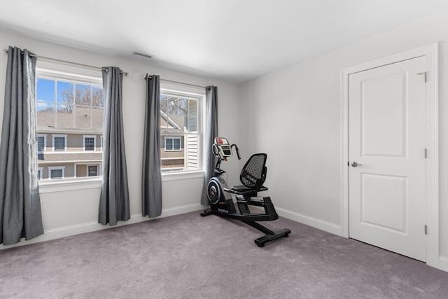 workout area featuring light colored carpet