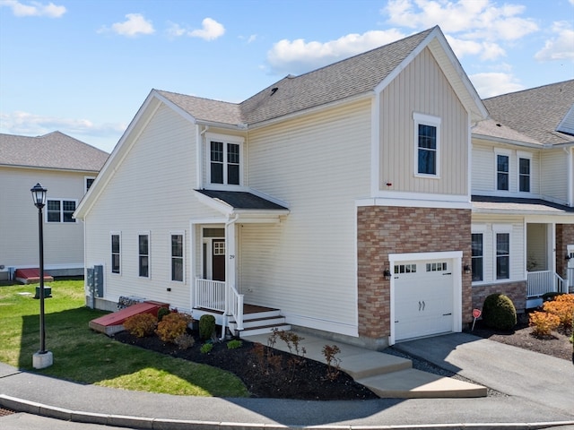 front facade with a garage and a front lawn