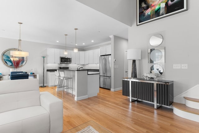 living room with light hardwood / wood-style flooring and sink