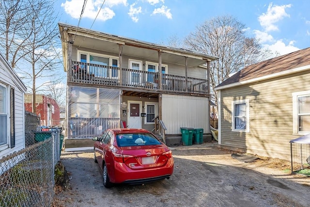 rear view of property with a balcony