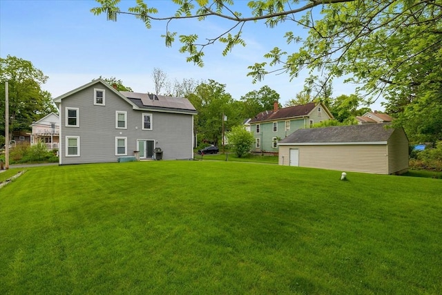 9 Green St, Brookfield, MA 01506 - back of house featuring a lawn, solar panels, and an outbuilding