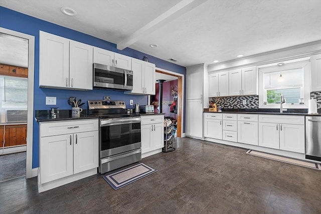 9 Green St, Brookfield, MA 01506 - kitchen featuring appliances with stainless steel finishes, a sink, dark countertops, beamed ceiling, and decorative backsplash