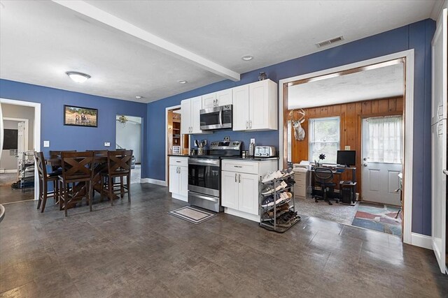 9 Green St, Brookfield, MA 01506 - kitchen featuring stainless steel appliances, dark countertops, white cabinets, baseboards, and beam ceiling