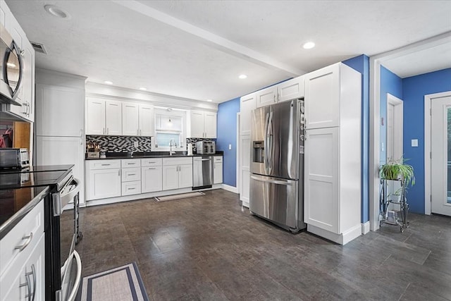9 Green St, Brookfield, MA 01506 - kitchen with appliances with stainless steel finishes, dark countertops, a sink, white cabinets, and tasteful backsplash
