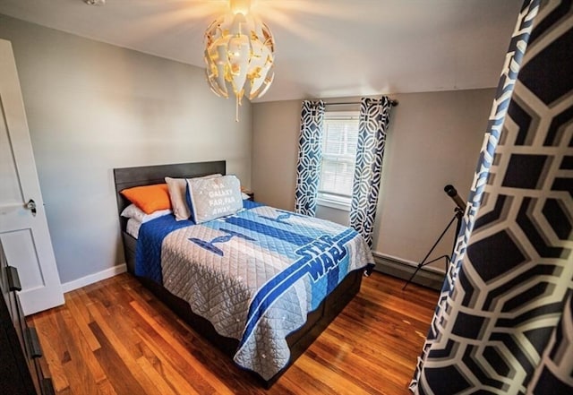 1 Gwinnett St, Boston, MA 02136 - bedroom with wood finished floors, a chandelier, and a baseboard radiator
