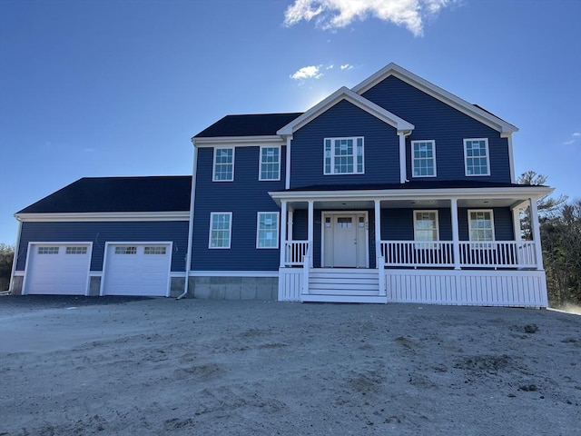 view of front of home with covered porch and a garage