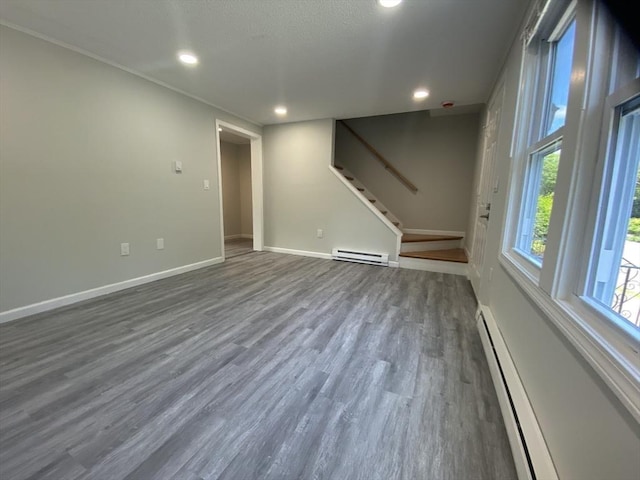 270 Sunderland Rd Unit 11, Worcester, MA 01604 - unfurnished living room featuring a baseboard radiator, dark wood-style floors, stairs, baseboards, and baseboard heating