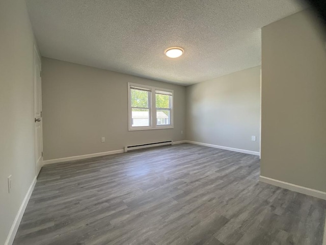 270 Sunderland Rd Unit 11, Worcester, MA 01604 - unfurnished room featuring a baseboard radiator, a textured ceiling, dark wood-style flooring, and baseboards