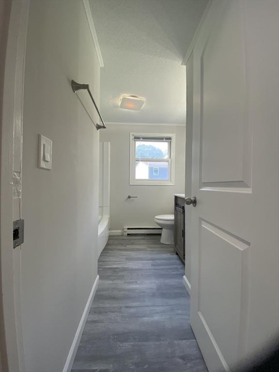 270 Sunderland Rd Unit 11, Worcester, MA 01604 - hallway featuring baseboard heating, baseboards, dark wood finished floors, a textured ceiling, and ornamental molding