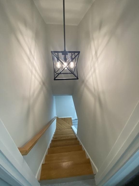 270 Sunderland Rd Unit 11, Worcester, MA 01604 - staircase with a chandelier, wood finished floors, and baseboards