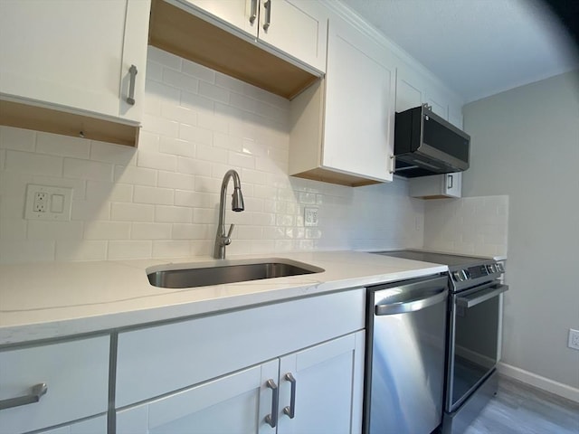 270 Sunderland Rd Unit 11, Worcester, MA 01604 - kitchen with stainless steel appliances, a sink, backsplash, and white cabinets