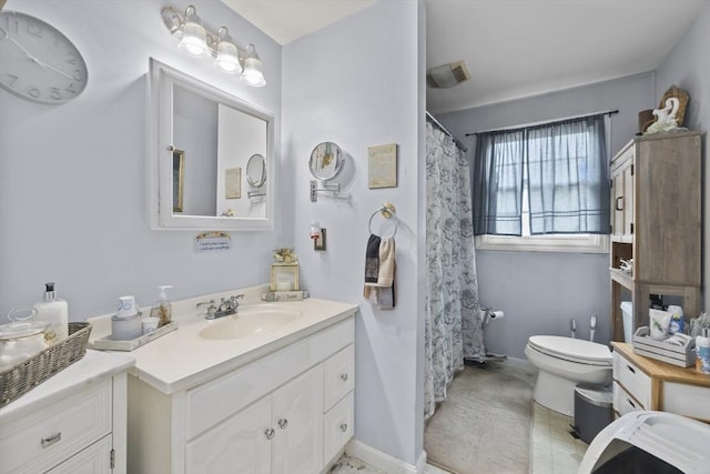 bathroom featuring toilet and vanity
