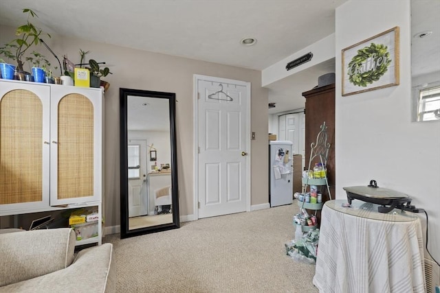 bedroom with carpet floors, baseboards, and freestanding refrigerator