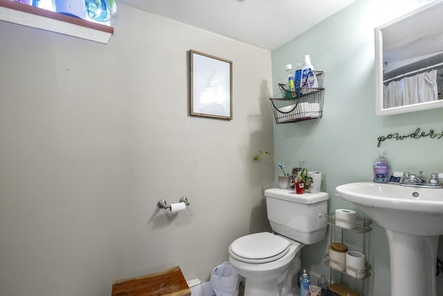 bathroom with toilet and a sink