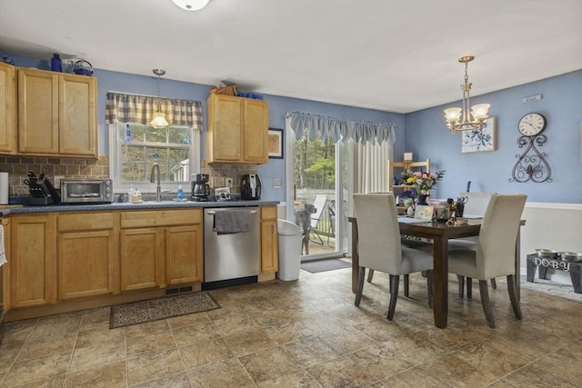 kitchen with dishwasher, decorative backsplash, a chandelier, and dark countertops