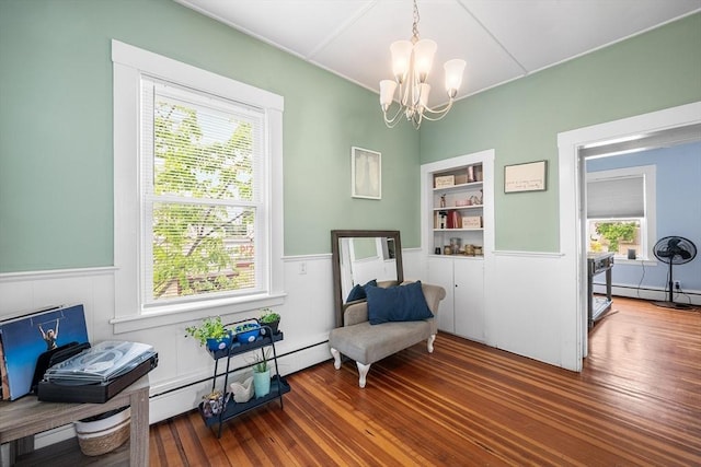 60 Lynnfield St, Lynn, MA 01904 - sitting room featuring a wainscoted wall, a chandelier, wood finished floors, built in shelves, and baseboard heating