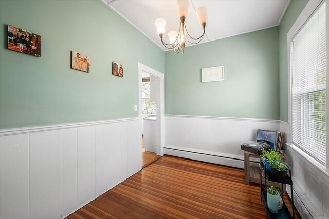 60 Lynnfield St, Lynn, MA 01904 - dining area featuring baseboard heating, wainscoting, healthy amount of natural light, a chandelier, and wood finished floors