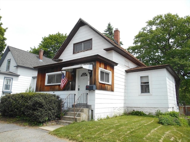 3 Anderson Ave, Worcester, MA 01604 - view of front of property featuring a chimney and a front yard