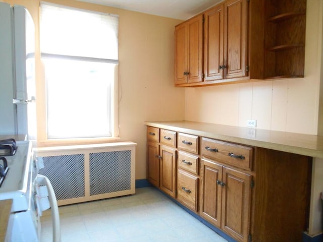 3 Anderson Ave, Worcester, MA 01604 - kitchen featuring radiator heating unit, brown cabinetry, and light countertops