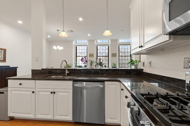 kitchen featuring a sink, white cabinets, and stainless steel appliances