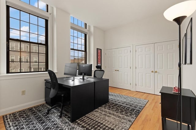 office area featuring baseboards and wood finished floors