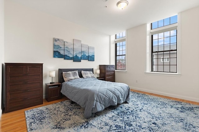 bedroom featuring baseboards and wood finished floors