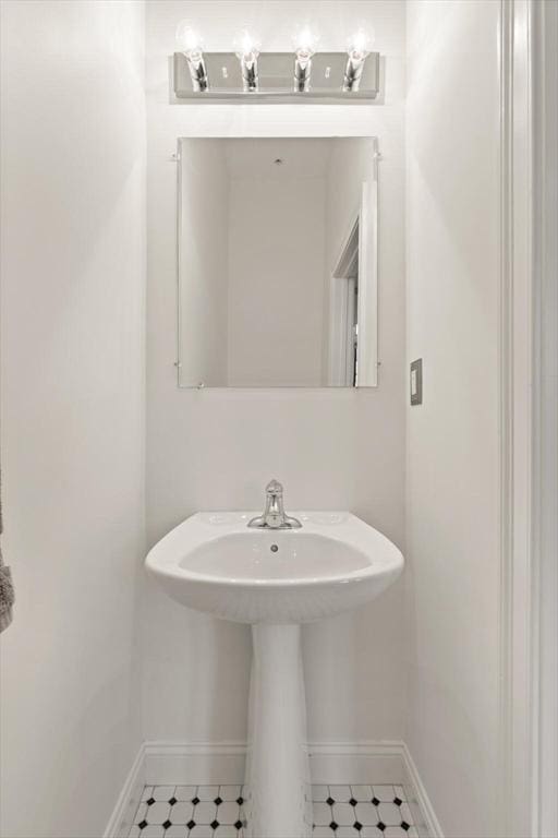 bathroom with baseboards and a sink