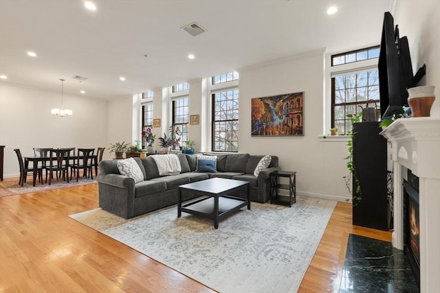 living room featuring recessed lighting, visible vents, and a wealth of natural light