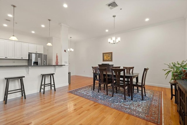 dining space featuring visible vents, baseboards, light wood finished floors, a notable chandelier, and recessed lighting